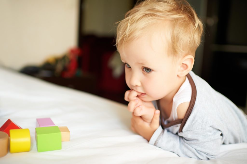 Cute little boy playing with blocks.