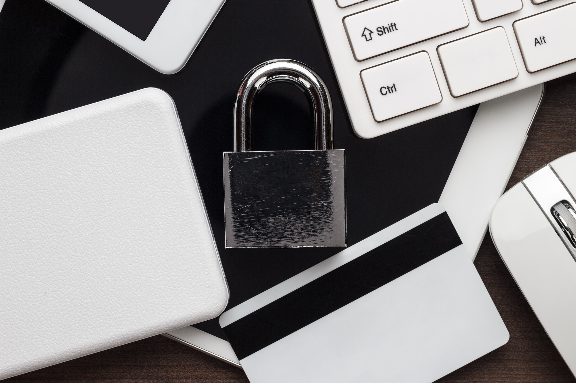 Padlock And Different Gadgets On The Wooden Office Table