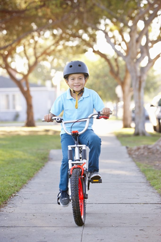 Boy Wearing Safety Helmet Riding Bike